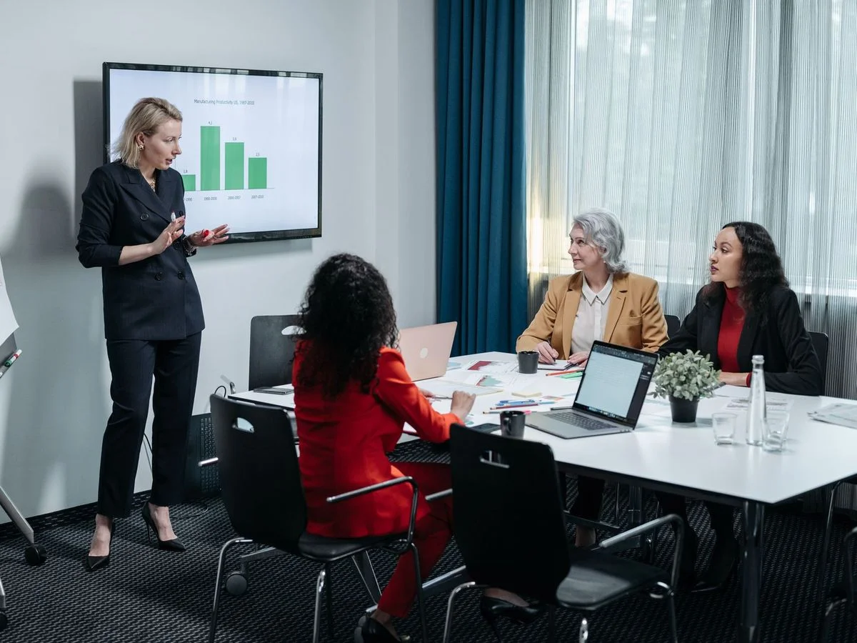 Formateur présentant une offre de formation à des dirigeants d'entreprise en réunion