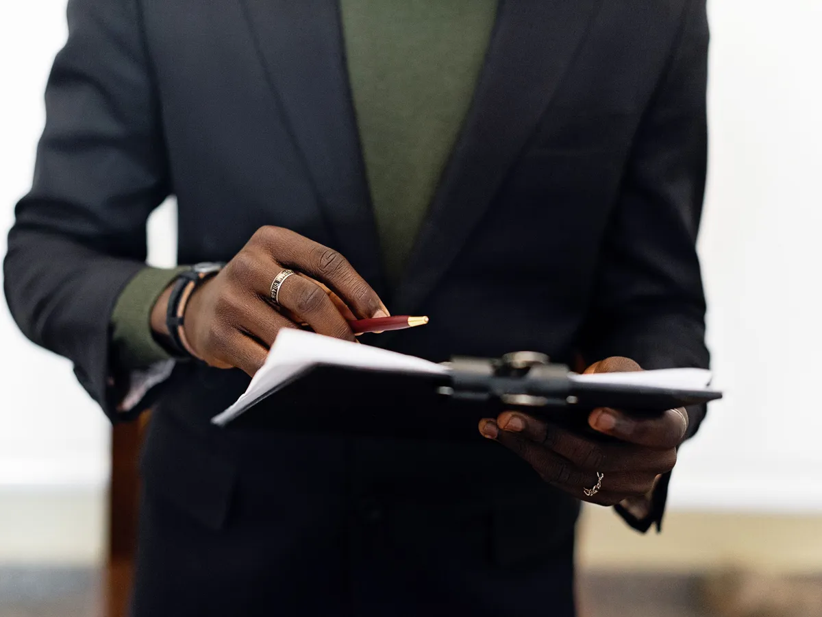 Consultant qualité tenant un support de préparation d'audit dans un cabinet